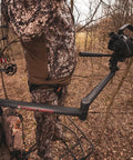 Hunter using Stiff Arm Tree Camera Arm Mount, Lightweight Aluminum With 360 Tool-Less Leveling for filming in a forest setup.