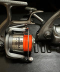 Two spinning reel handles with orange fishing line, showing Aluminum Alloy Fishing Reel Cap Replacement For Spinning Reels