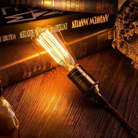 6 Pack Edison Light Bulbs With Squirrel Cage Filament, 60W, 2200K amber warm bulb on wooden table for home decor