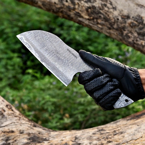 Hand holding Damascus Knife Making Kit With DIY Knife Set Includes Meat Cleaver Blank against a natural backdrop