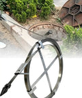 Heavy Duty Flat Steel Sewer Rod And Drain Snake Tool Forged From Tempered Metal in use near a sewer access point.