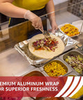 Person making a wrap using Heavy Duty 18 Inch Wide Aluminum Foil Roll, 500 Feet, Food Safe, Tear Resistant for Cooking.