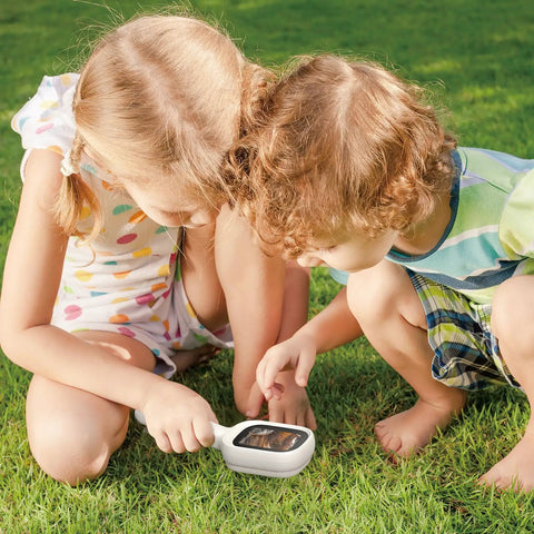 No Fuss Autofocus Digital Microscope With A 2.8 Inch IPS Screen For Quick Sharp Focus And Photo Capture Dual LED Illumination For Clear Detail Simple One Button Use That Anyone Can Master Ideal For Students Hobbyists And Makers, kids using handheld microscope on grass