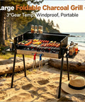 Foldable Charcoal Grill With Three Temperature Settings, Windproof Camping BBQ on beach with food and storage shelves