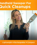 Woman holding Rocket Cordless Air Broom For Indoor And Outdoor Cleaning in packaging with orange accents.