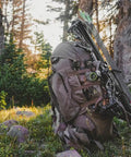 Full Curl Combo Stone Day Pack with Game Hauling Frame, 2000 Cubic Inch Capacity, resting in forest setting.