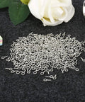 500 Pieces 4 By 8 Millimeter Small Screw Eye Pins For Jewelry Making And DIY Art Projects on dark fabric