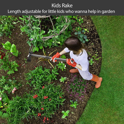 Child using kids rake in garden with adjustable handle, surrounded by vibrant green plants and flowers.