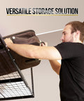 Man placing a bag on Overhead Garage Shelving Storage Rack Adjustable 3 ft by 6 ft Ceiling Organizer Shelf Space Saving Heavy Duty