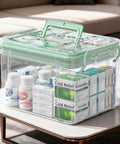 Grab And Go See Through Medicine Storage Box Set With Lids 2 Pack Portable First Aid Organizer With Handle Stackable Medical Supply Storage For Family Home Office Bathroom Bedroom Green clear plastic box with pills and medicine boxes on a table