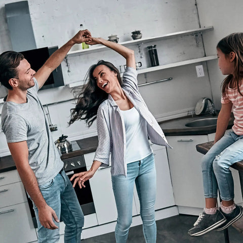 Family enjoying time together in a modern kitchen setting.