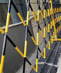 Adjustable Telescopic Safety Barrier With Slick Glide Casters, Grab And Go Pop Up crowd control fence in black and yellow.