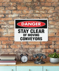 Stay Clear of Moving Conveyors Industrial Warning Sign 8 By 12 Inches Aluminum Indoor Outdoor Wall Decor displayed against brick wall.