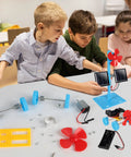 Kids assembling 4 In 1 Solar Power And Electric Motor STEM Kit with solar car parts and turbines on a table.