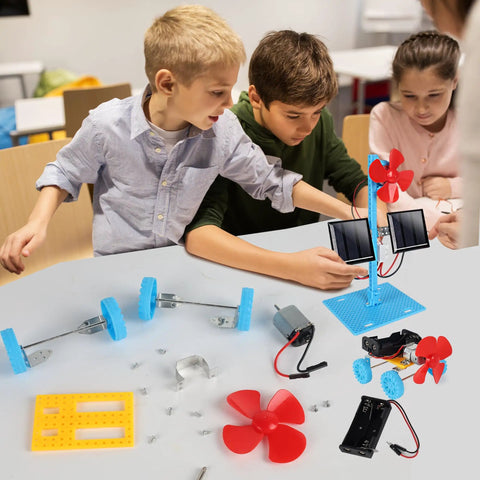 Kids assembling 4 In 1 Solar Power And Electric Motor STEM Kit with solar car parts and turbines on a table.