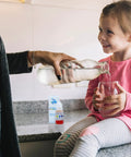 Dead Nuts Accurate Alkaline Water pH Test Kit For Drinking Liquids Delivers Knockout Precision in a kitchen while pouring water into a glass.