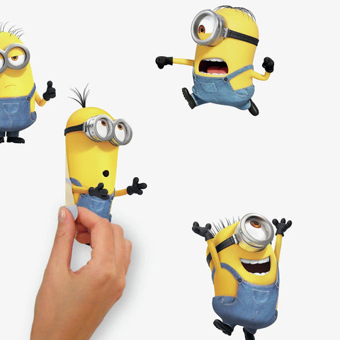 Person applying Minions The Rise Of Gru Peel And Stick Vinyl Wall Decals Set Of 30 for kids rooms, repositionable on surfaces.