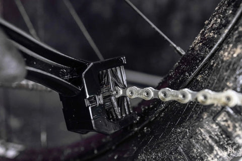 Go To Road Gravel MTB Bicycle Chain Cleaning Brush Three Sided Tool in use on a dirty bike chain showing tough bristles.