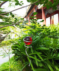 Gazing Ball Spiral Wind Spinner With Stainless Steel Tail, Hanging Swivel Hook, Weather Resistant Indoor Outdoor Decor In Silver And Red, 13 Inch Overall Height, 2 Inch Glass Ball, 2.5 Inch Spiral hanging in garden with red glass ball
