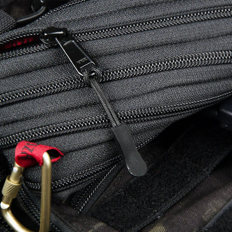 Black zipper with durable non-slip PU grip zipper pull tab extension attached to gray backpack.