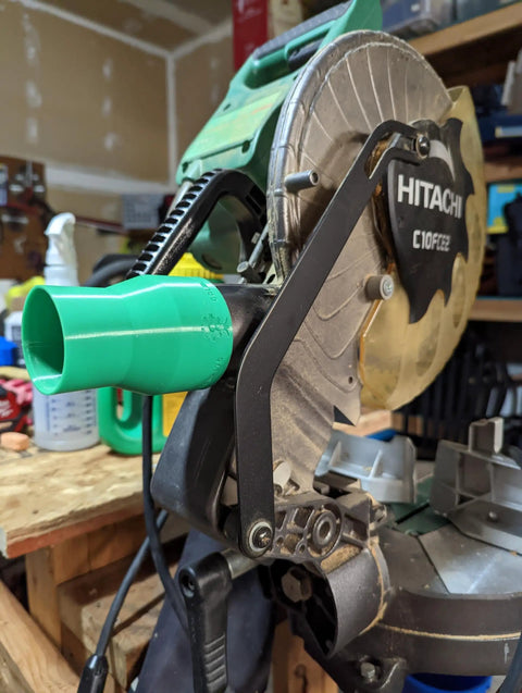 Vacuum Dust Adapter For Metabo HPT And Hitachi Miter And Chop Saws Two And A Half Inch Green Dust Collection Attachment For 10 And 12 Inch Saws installed