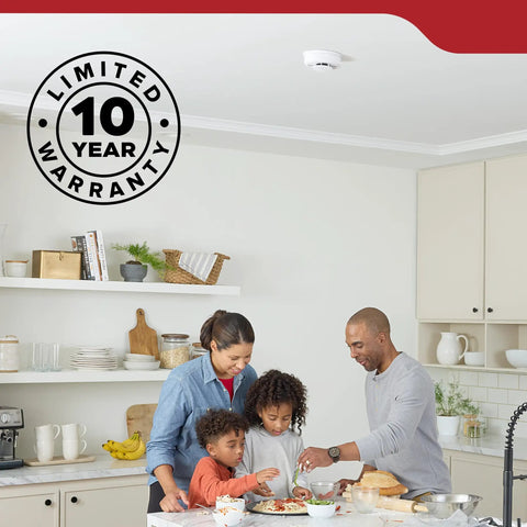 Family cooking together in a kitchen with Two Pack Smoke Detector AA Battery Powered Model 20SDR visible on ceiling.