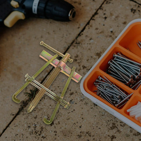 Heavy Duty Carbon Steel Two Jaw Gear Bearing Puller With Reinforced Grips positioned on work surface with screws nearby.