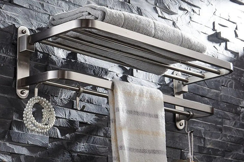 Stainless Steel Towel Rack With Double Towel Bar And Hooks For Bathroom Wall Mounted Shelf Slick Space Saving Foldable Brushed Nickel Finish Heavy Duty All In One Multifunctional Storage Organizer Rustproof 304 Stainless Steel Construction displaying towels and accessories against a stone wall backdrop.