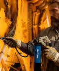 KRETLAW grease gun kit with blue cylindrical body, pistol-grip handle and flexible hose in use.