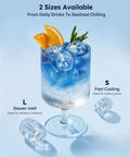 Fast Countertop Ice Maker Turns Out Eight Bullet Shaped Cubes In Six Minutes While Pumping Twenty Six Point Five Pounds Daily With Ample Water Reservoir For No Sweat Bar Setup And Always Chill Cocktails Or Quick Saturday Sips. Ice cubes chill a blue drink with orange garnish, showcasing size options for cocktails and seafood.