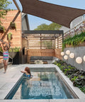 10x12 Brown Outdoor Shade Sail Canopy With UV Resistant Permeable Fabric for patio shading over a backyard pool and pergola.