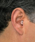 Man wearing High Fidelity Ear Plugs For Concerts And Musicians With Universal Fit, Standard Large And Foam Tips.