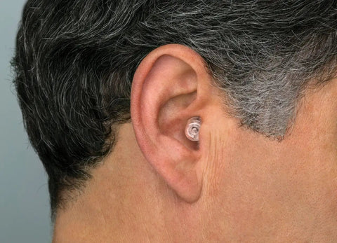 Man wearing High Fidelity Ear Plugs For Concerts And Musicians With Universal Fit, Standard Large And Foam Tips.