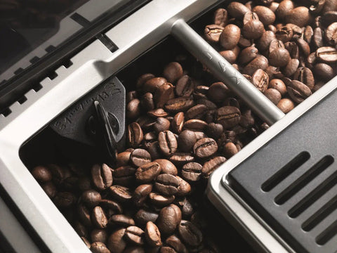 Fully Automatic Espresso And Cappuccino Maker With Precision Burr Grinder For Smooth Milk Frothing And Solid Stainless Steel Cabinet Profile showcasing roasted coffee beans in grinder compartment.
