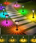 Lit Ultra Bright Solar Pathway Lights Eight Pack With Remote Color Changing and Warm White Modes illuminating a garden path.