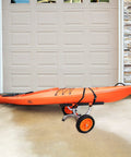 Heavy Duty Kayak Cart With 450 Lbs Load Capacity Detachable Canoe Trolley parked on pavement with orange kayak