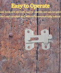 Close-up of barn door latch installed on wooden door, showing 4 Pack 70mm 2.75 Inch Barn Door Latches With 180 Degree Flip Lock For Sliding Doors Privacy Locks For Bathroom Cabinets And Pet Doors Stainless Steel Screws Included No-Fuss Install.