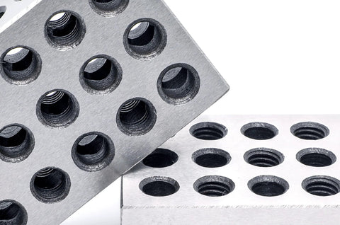 Pair of 1 in x 2 in x 3 in precision steel 123 blocks with 23 holes shown in angled and flat views.