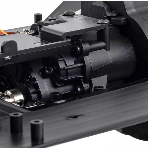 Close-up of One Tenth Scale RC Crawler Chassis Kit with 313mm wheelbase, showing nylon frame and 2-speed gearbox.