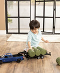Child playing with Chevy Pickup Truck Toy With Lights And Trailer For Indoor And Outdoor Play A Real Work Rig Experience 1 To 16 Scale