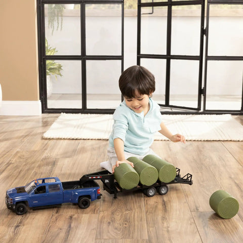 Child playing with Chevy Pickup Truck Toy With Lights And Trailer For Indoor And Outdoor Play A Real Work Rig Experience 1 To 16 Scale