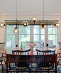 Mid-Century Glass Globe Pendant Light Fixture In Black And Gold, Semi-Flush Ceiling Chandelier above dining table