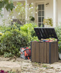 Backyard Must-Have Everwood 30 Gallon Resin Outdoor Storage Box And Patio Side Table in garden with lid open, walnut finish