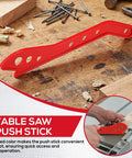 Red Table Saw Push Stick For Woodworking on workbench, ergonomic handle design, hand protection safety accessory for safer cuts.