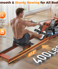 Man using water rowing machine for home gym with foldable wooden frame 400 lb capacity quiet ergonomic seat immersive water resistance built in monitor and Bluetooth app sync smooth full body cardio rower low maintenance, side view.