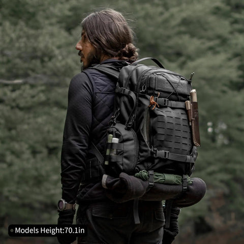 Man carrying 35L MOLLE Tactical Backpack For Men Cordura 915D Durable Fabric Heavy Duty Hiking Camping Survival Pack in forest
