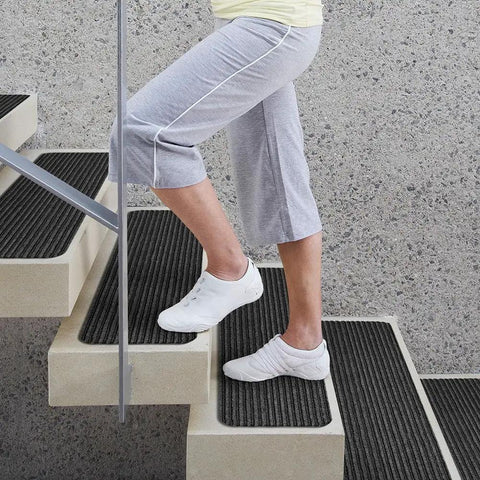 Set of 15 Skid Resistant Double Ribbed Carpet Stair Treads Smokey Black 9x36 Inches, person walking on stairs with treads