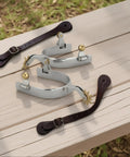 Two Piece Horse Spurs Set For Cowboy Boots With Adjustable Leather Spur Straps on wooden surface, stainless steel, copper gears.