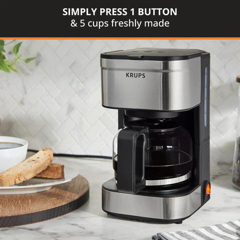 Compact Five Cup Coffee Maker With Stainless Steel Design And Pause And Brew Function Keep Warm Reusable Filter Drip Free Carafe Perfect For Small Kitchens Or Offices on kitchen counter
