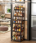Roomy 5 Tier Trapezoid Liquor Cabinet For Home Bar Space with dozens of bottles on a black wooden rack.